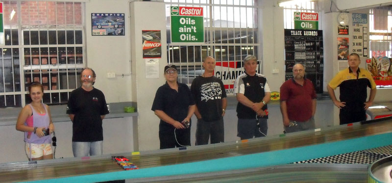 Drivers prior to start of the 2012 Australia Day Classic 'Retro' CanAm race.<br />L to R;<br />Stephanie ?, Geoff Little, Stewart Amos, Charles Rickards, Darryl Toole, Brad ?? and James Colfax.